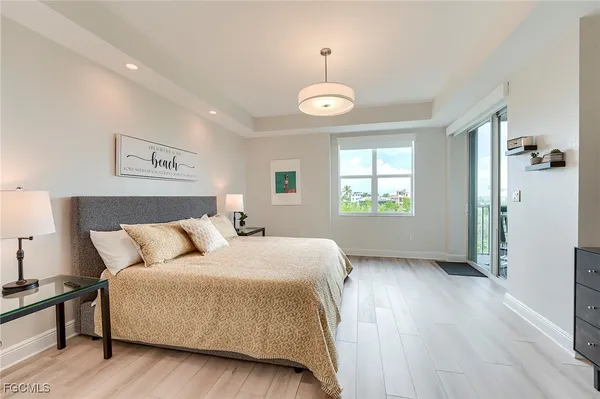 a spacious bedroom with a bed and a window