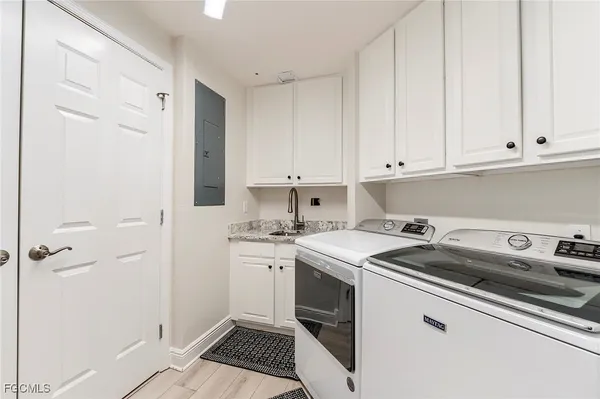 a kitchen with a sink stove and cabinets