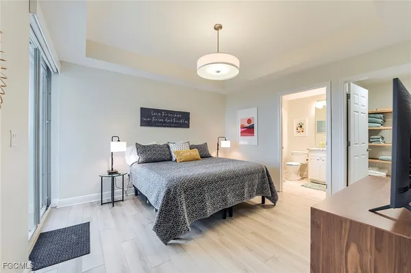 a bedroom with a bed and a table with wooden floor