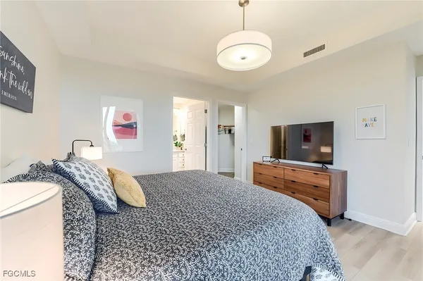 a bedroom with furniture and a flat screen tv