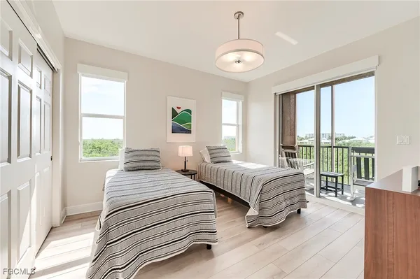 a spacious bedroom with two beds and a large window