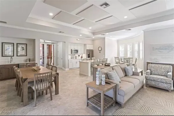 a living room with furniture a dining table and kitchen view
