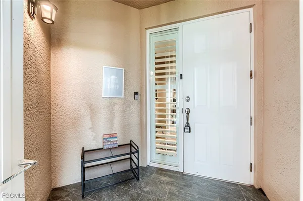 a view of a hallway with windows and cabinet