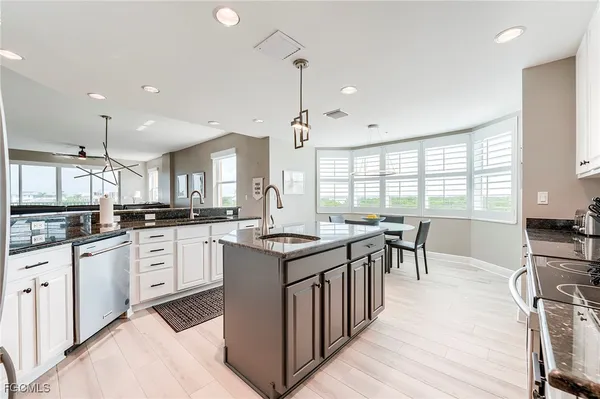 a kitchen with sink stove and cabinets