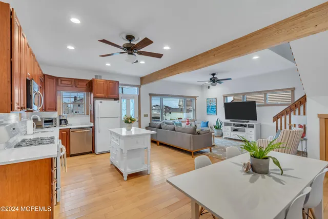 a living room with furniture two window and a table