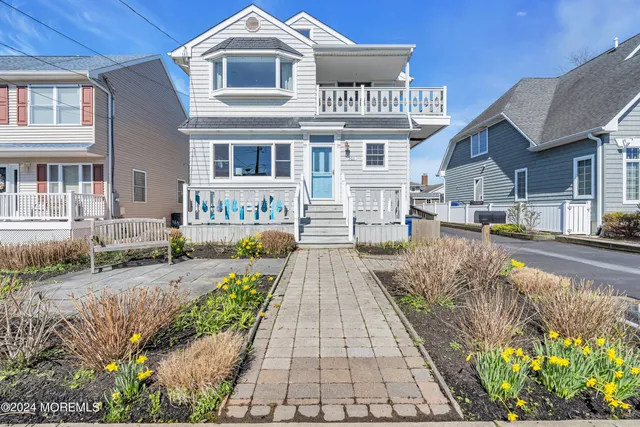 a front view of a residential apartment building with a yard