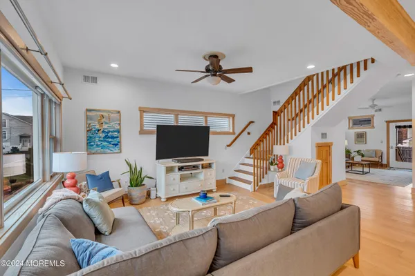 a living room with furniture and kitchen view