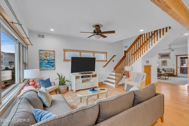 a living room with furniture and kitchen view