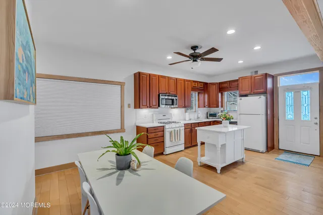 a kitchen with stainless steel appliances granite countertop a sink a stove a microwave and cabinets