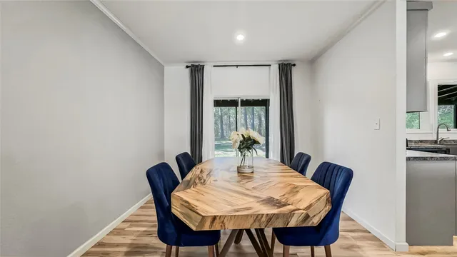 a view of a dining room with furniture and window