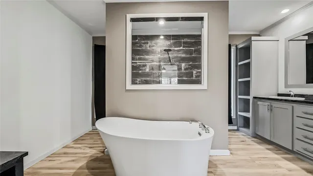 a bathroom with a granite countertop sink and a window
