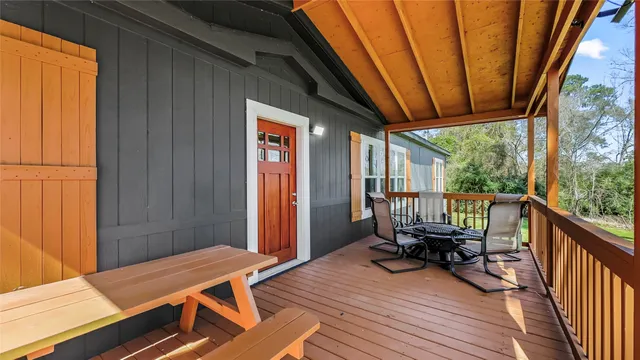 a view of balcony with wooden floor and seating space