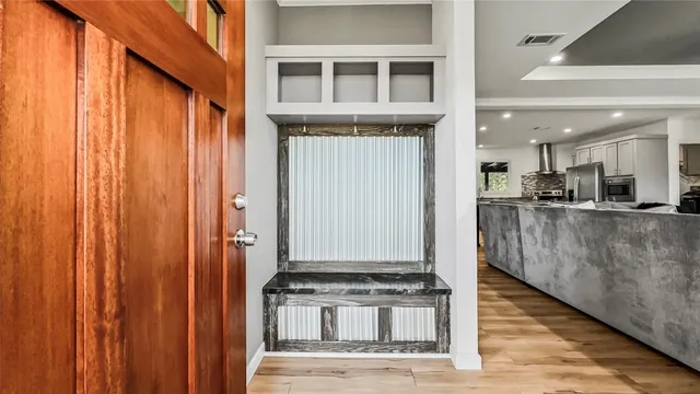 a view of a kitchen with stainless steel appliances granite countertop a refrigerator and a stove top oven
