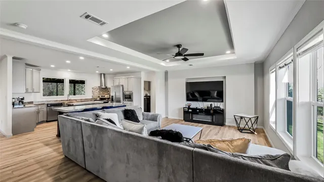 a kitchen with stainless steel appliances granite countertop a sink a stove and a refrigerator