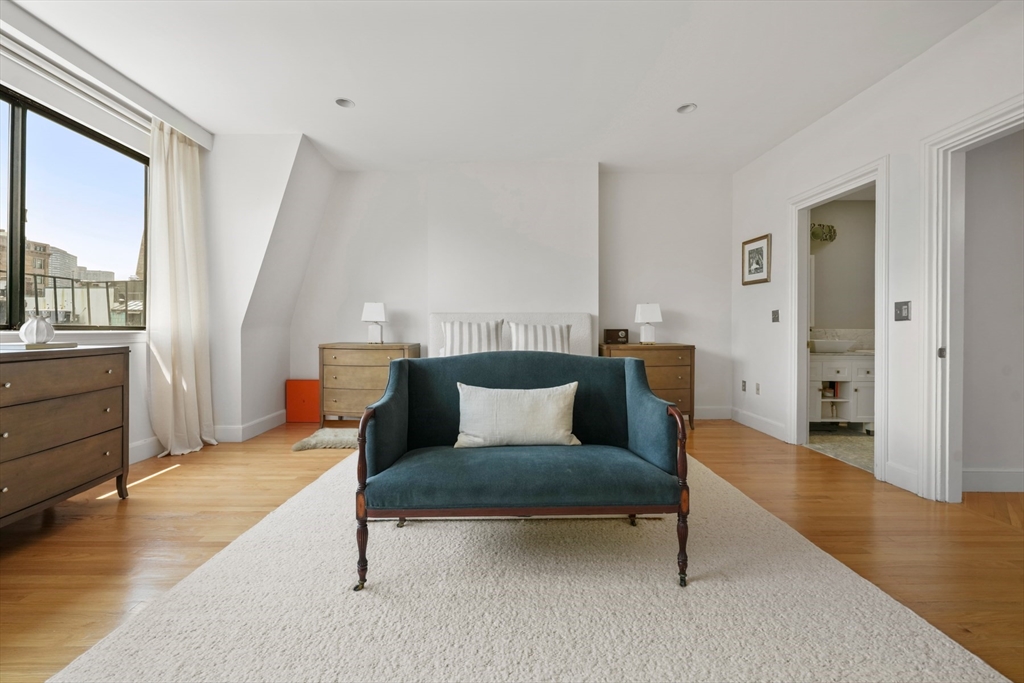 129 Beacon Street, Unit PH Boston, MA 02116 - Photo 15 of 40 a living room with furniture and a wooden floor