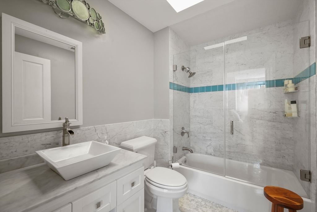 129 Beacon Street, Unit PH Boston, MA 02116 - Photo 17 of 40 a bathroom with a sink a toilet and shower