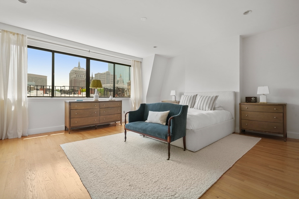 129 Beacon Street, Unit PH Boston, MA 02116 - Photo 19 of 40 a bedroom with furniture and a large window