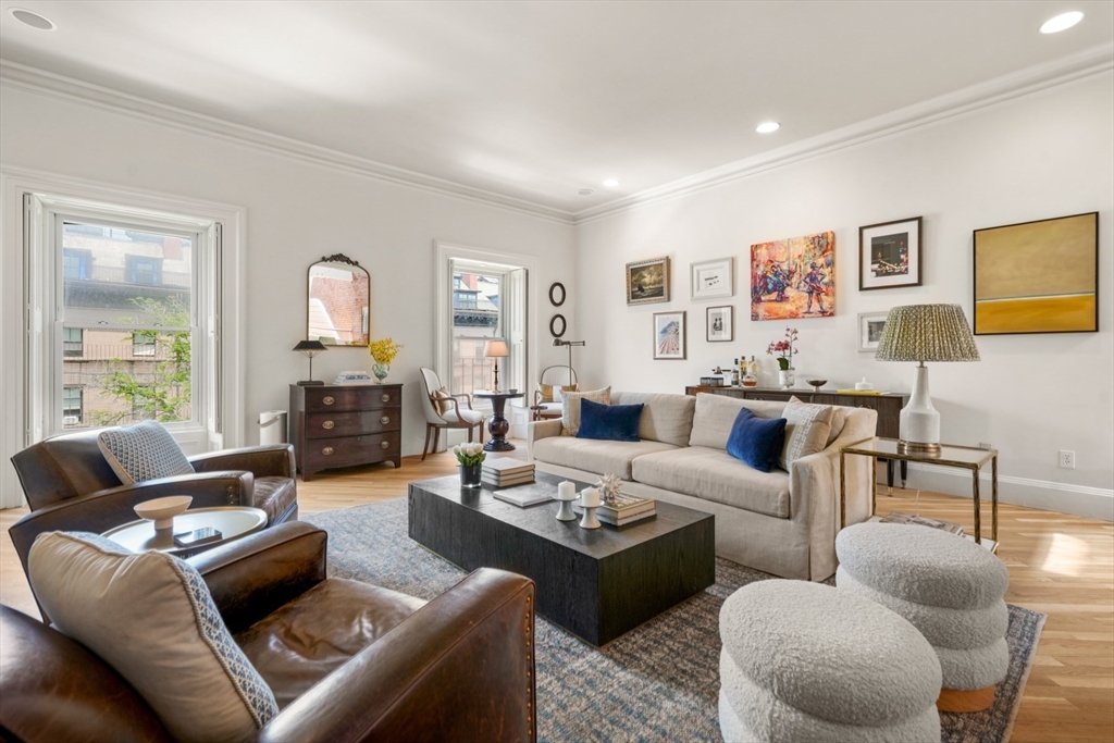 129 Beacon Street, Unit PH Boston, MA 02116 - Photo 2 of 40 a living room with furniture fireplace and a window
