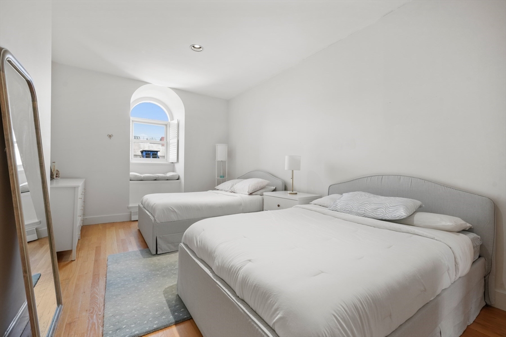 129 Beacon Street, Unit PH Boston, MA 02116 - Photo 21 of 40 a bedroom with two beds and a mirror