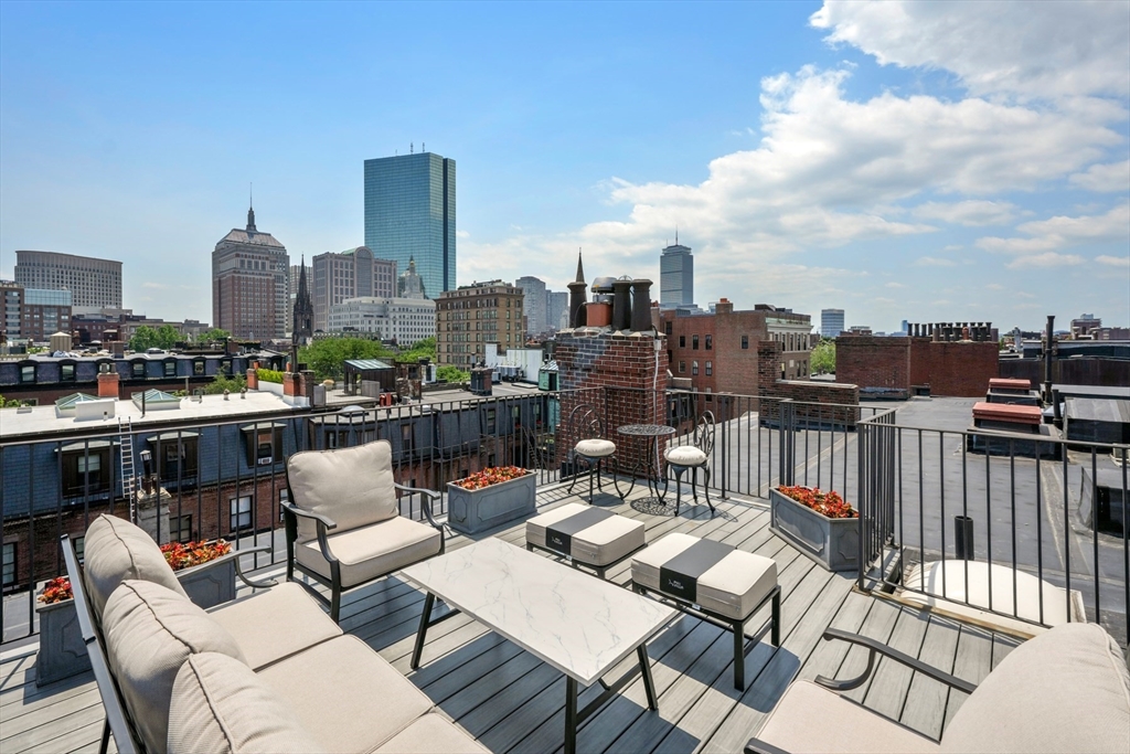 129 Beacon Street, Unit PH Boston, MA 02116 - Photo 26 of 40 a view of city from terrace with seating