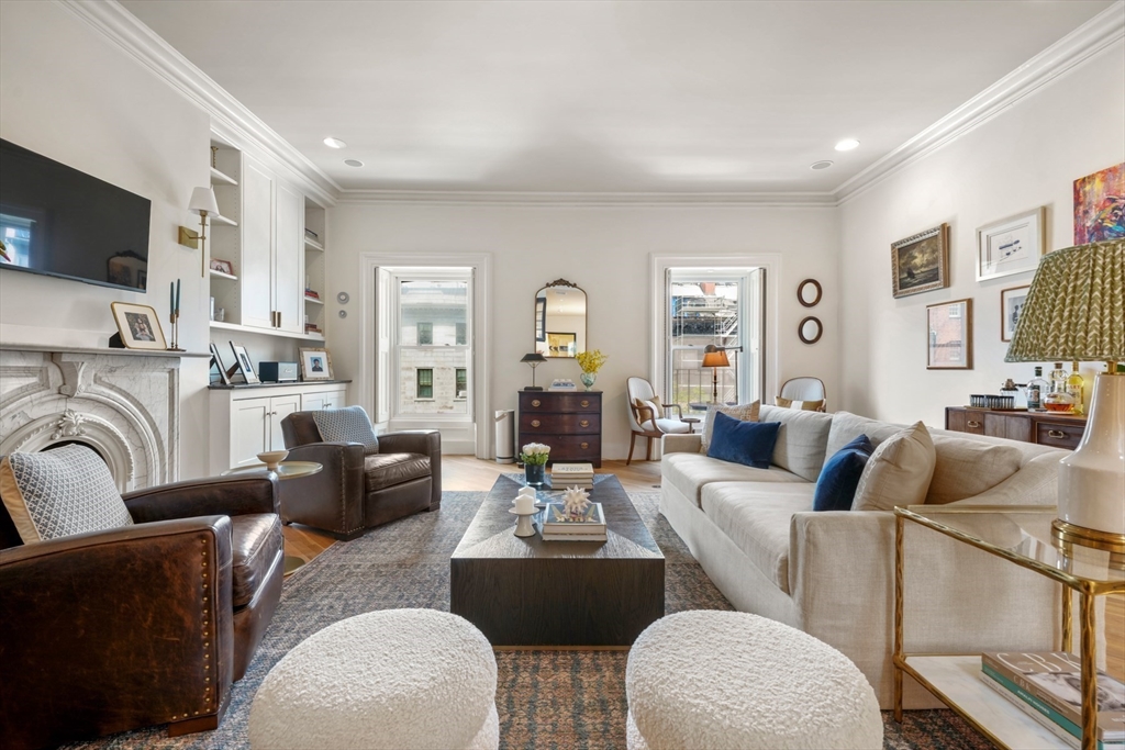 129 Beacon Street, Unit PH Boston, MA 02116 - Photo 3 of 40 a living room with fireplace furniture and a flat screen tv