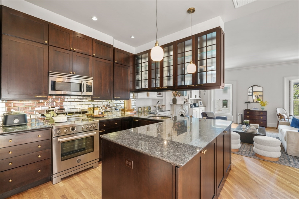 129 Beacon Street, Unit PH Boston, MA 02116 - Photo 7 of 40 a kitchen with a stove sink and cabinets