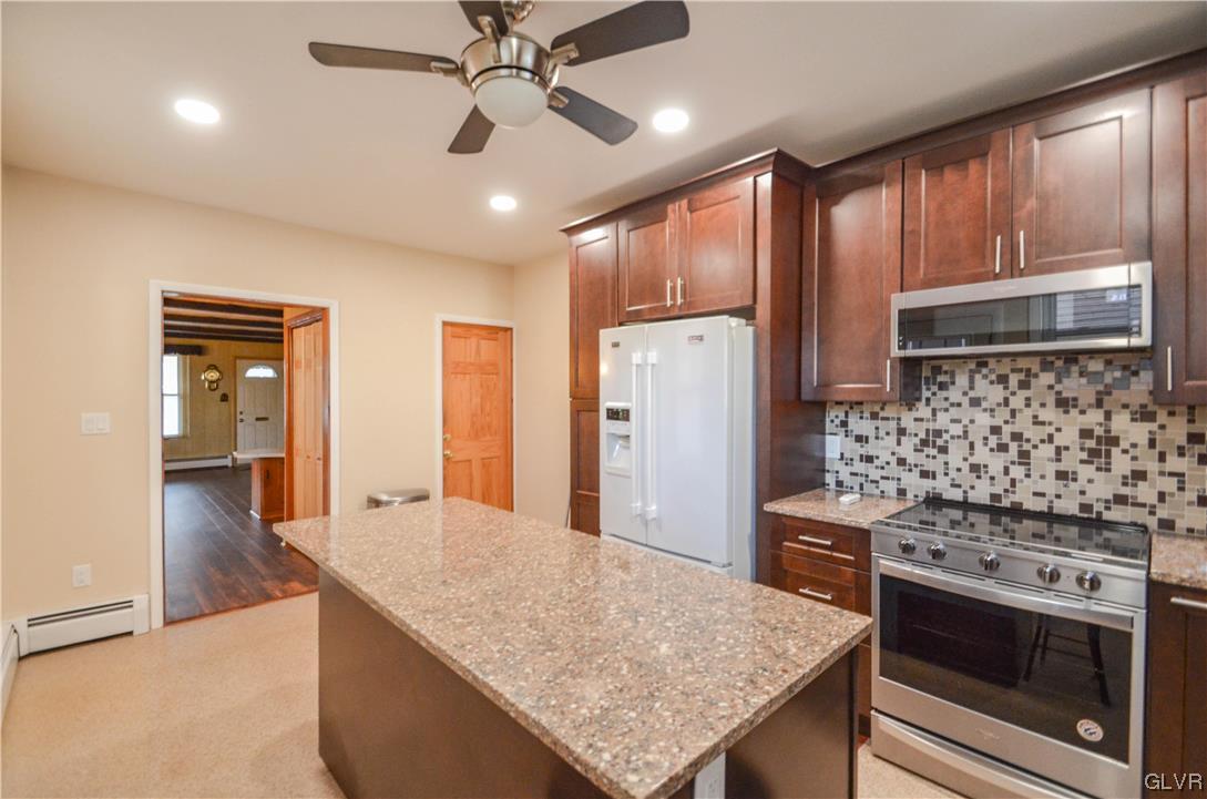 33 South 5th Street Emmaus, PA 18049 - Photo 5 of 24 a kitchen with stainless steel appliances granite countertop a stove refrigerator and cabinets