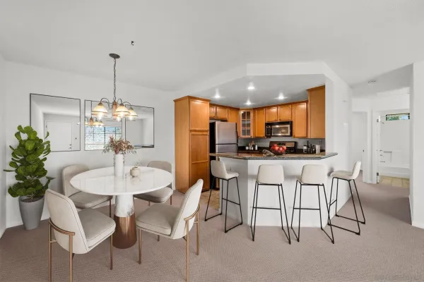 a dining room with furniture a kitchen and kitchen view