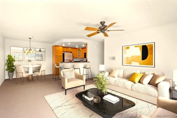 a living room with furniture a rug and a chandelier