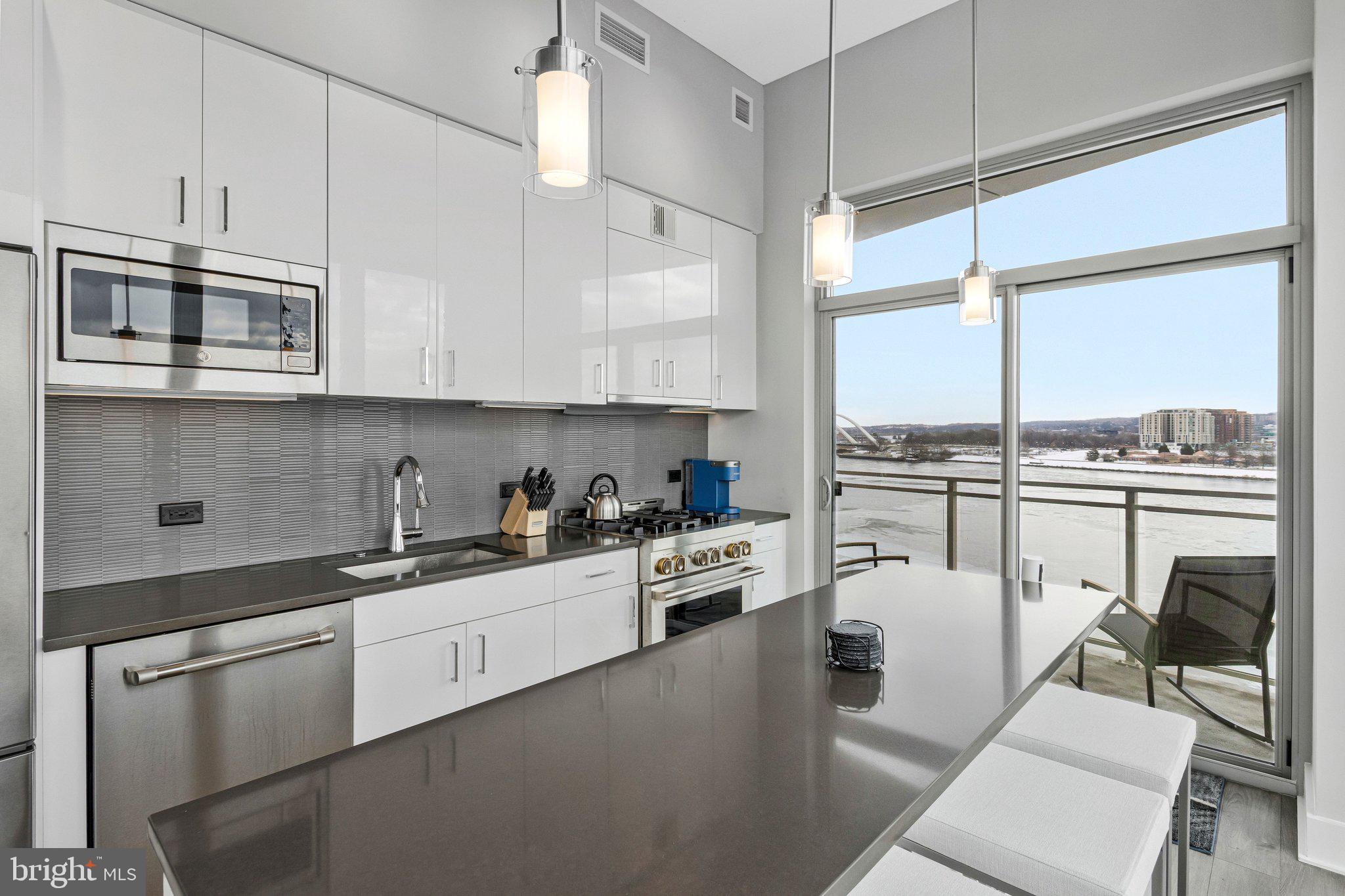 88 V Street Southwest, Unit 801 Washington, DC 20024 - Photo 15 of 58 a kitchen with white cabinets and appliances