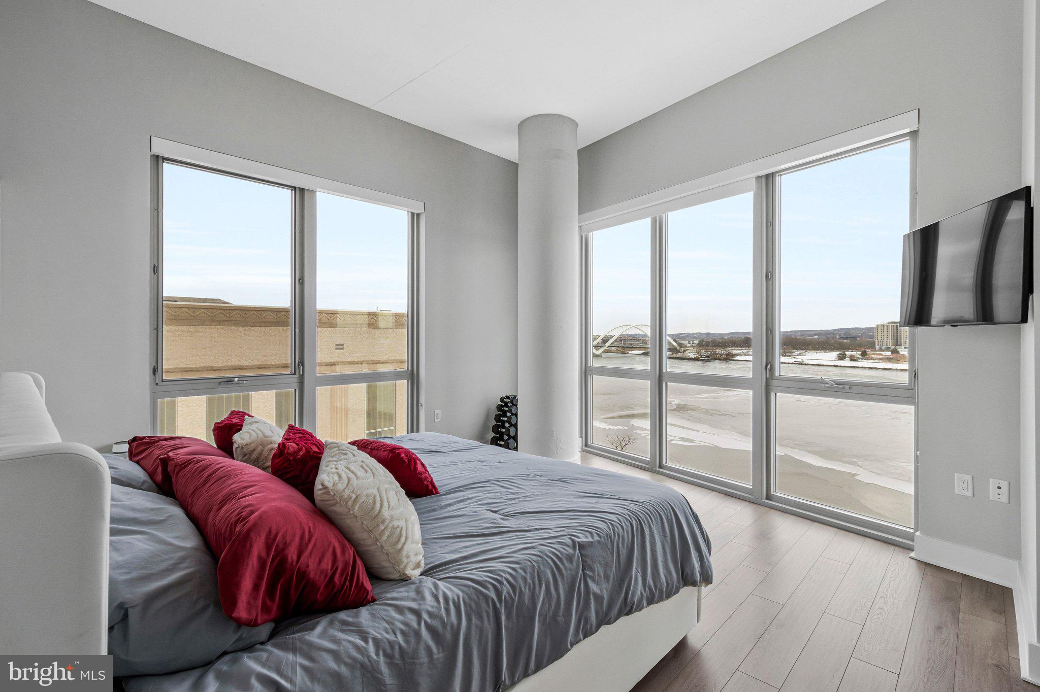 88 V Street Southwest, Unit 801 Washington, DC 20024 - Photo 24 of 58 a bed sitting in a bedroom next to a window