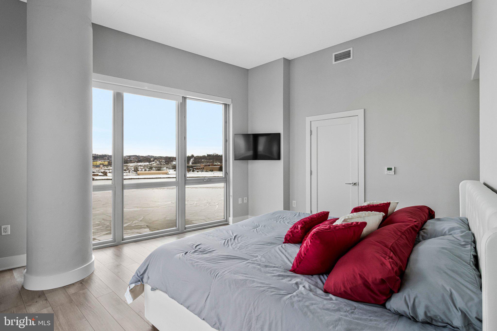 88 V Street Southwest, Unit 801 Washington, DC 20024 - Photo 27 of 58 a bed sitting in a bedroom next to a window