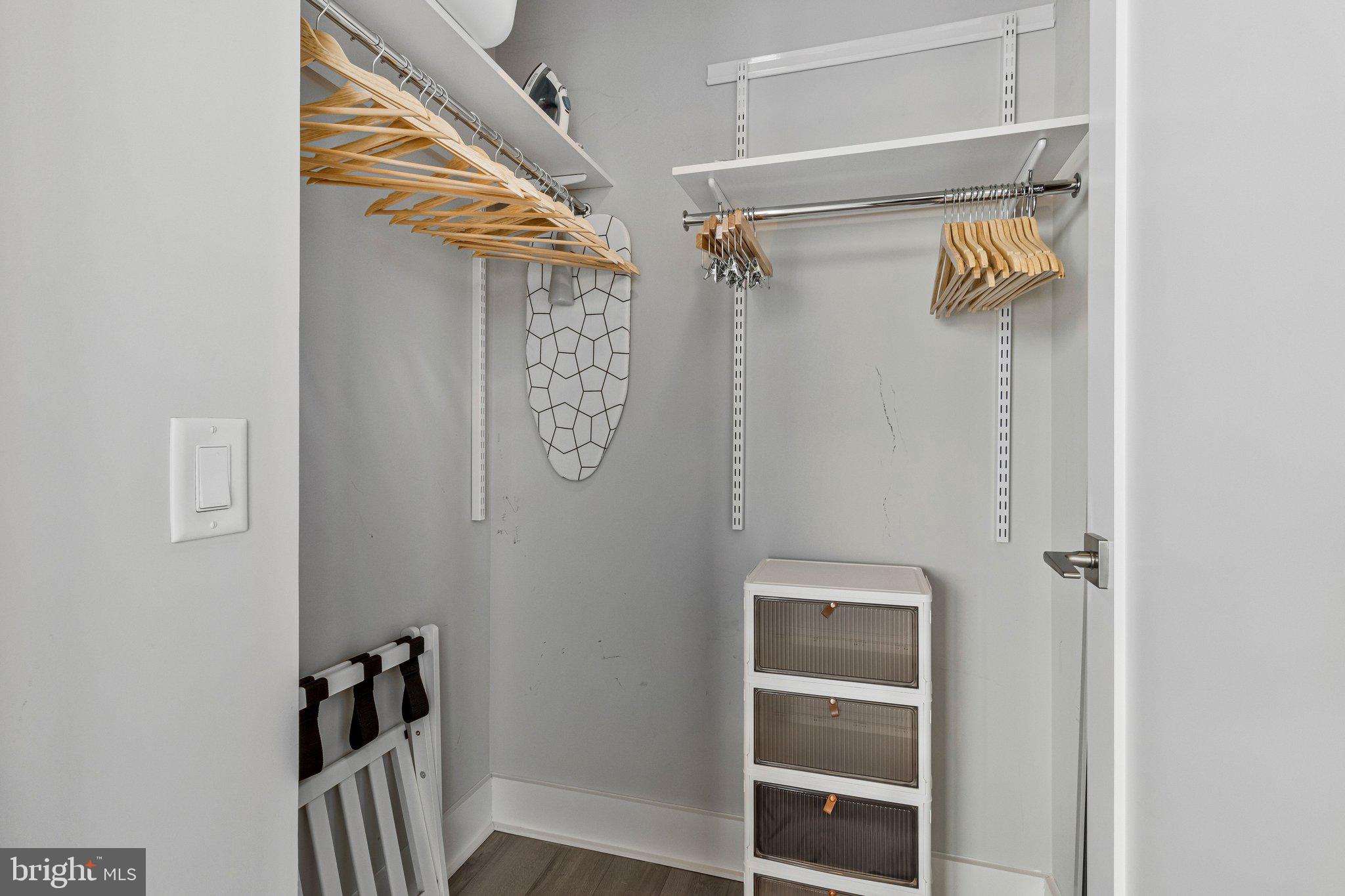 88 V Street Southwest, Unit 801 Washington, DC 20024 - Photo 29 of 58 a view of walk in closet with clothes and shoes
