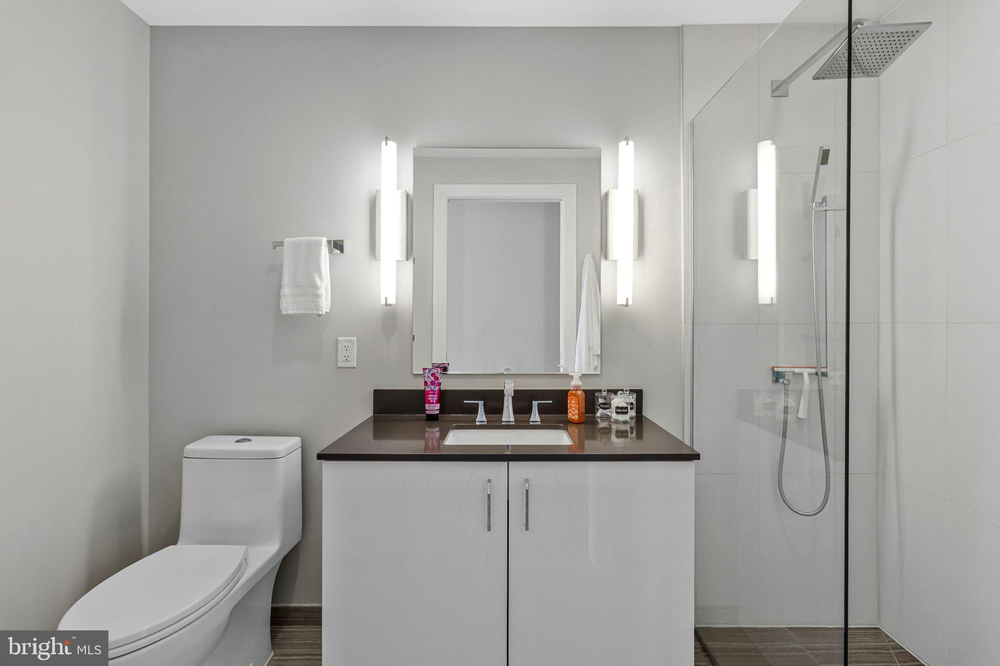 88 V Street Southwest, Unit 801 Washington, DC 20024 - Photo 30 of 58 a bathroom with a toilet sink shower and mirror