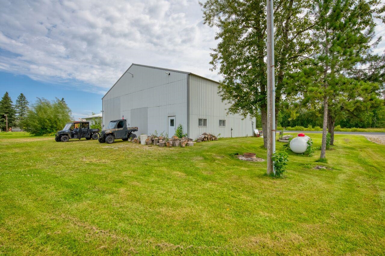 112 Highway 71 Big Falls, MN 56627 - Photo 18 of 35 View of side of property featuring a pole building, an outdoor structure, and a yard