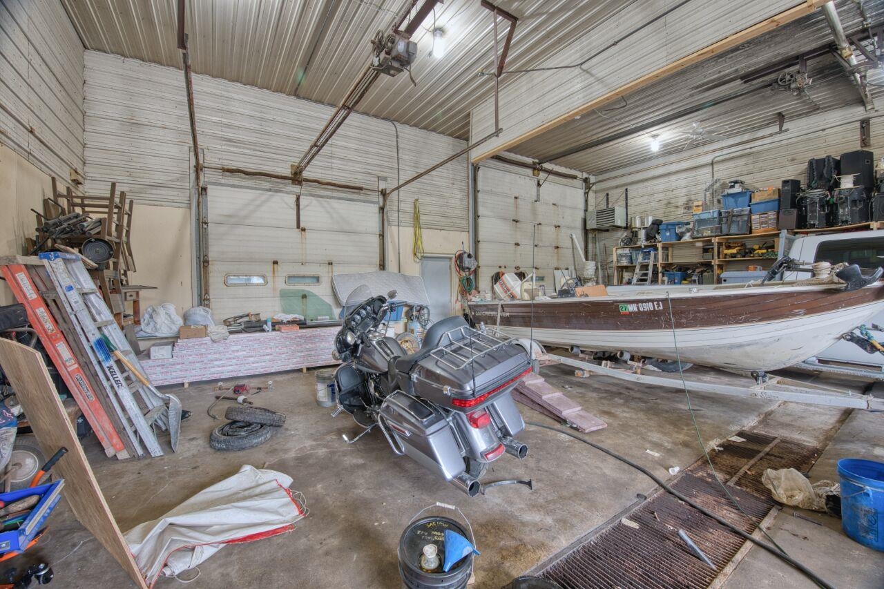 112 Highway 71 Big Falls, MN 56627 - Photo 6 of 35 Garage featuring metal wall, a workshop area, and a garage door opener