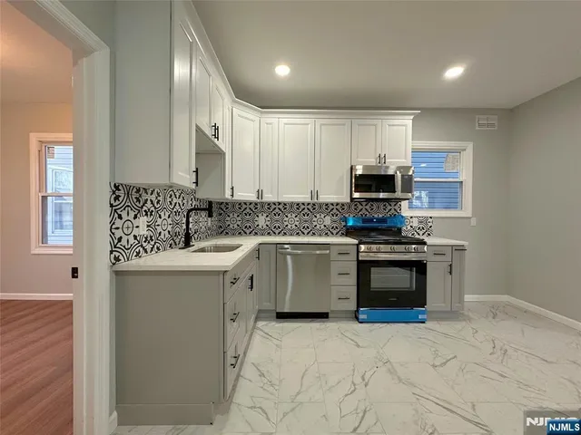 a kitchen with a sink stove and microwave