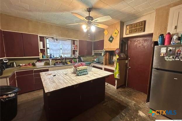 419 West Main Street Lometa, TX 76853 - Photo 4 of 16 a kitchen with sink refrigerator and cabinets