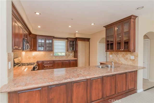 an empty room with windows and fireplace