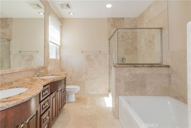 a bathroom with a bathtub a toilet and a shower