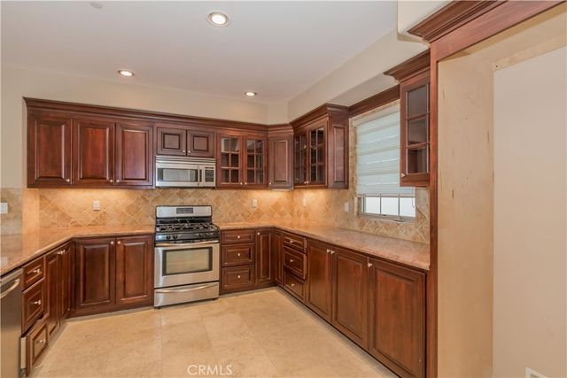 a kitchen with stainless steel appliances granite countertop a stove and a sink