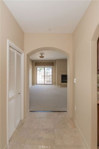 an empty room with a fireplace and windows