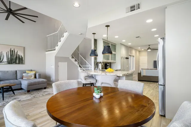 a living room with furniture and kitchen view