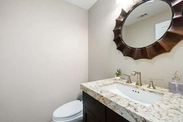 a bathroom with a double vanity sink mirror and shower