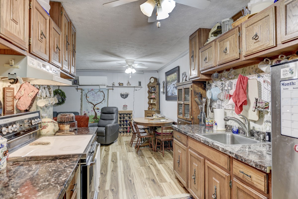 2344 Granny Wright Lane Hermitage, TN 37076 - Photo 21 of 37 a kitchen with stainless steel appliances granite countertop a sink dishwasher and cabinets with wooden floor