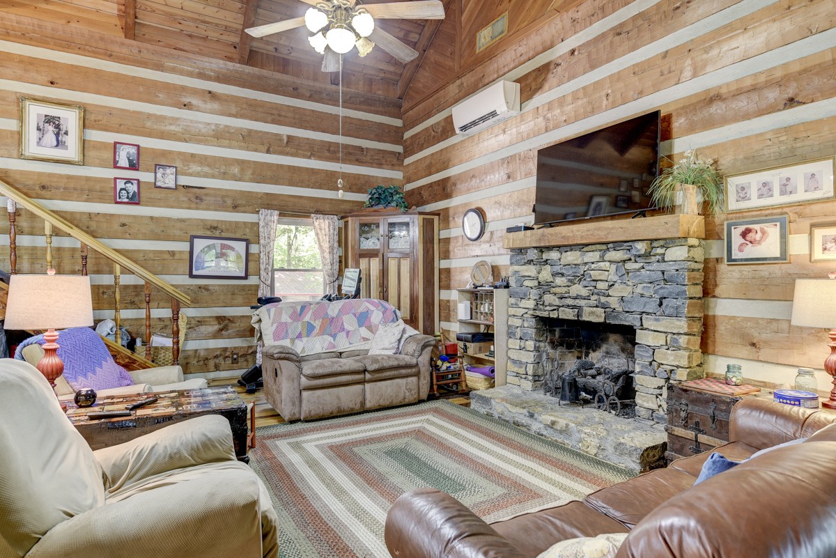 2344 Granny Wright Lane Hermitage, TN 37076 - Photo 4 of 37 a living room with furniture a flat screen tv and a fireplace