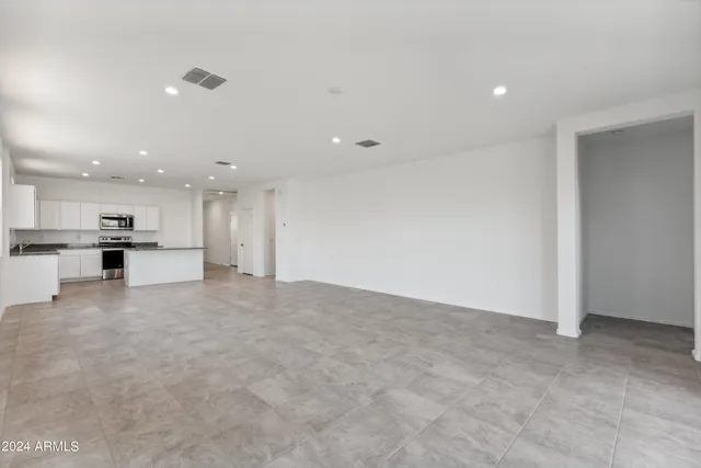 a view of kitchen with kitchen island and stainless steel appliances