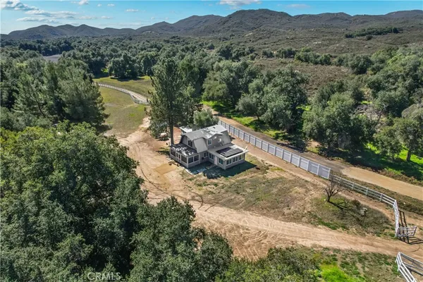 a view of a house with a mountain and a forest view
