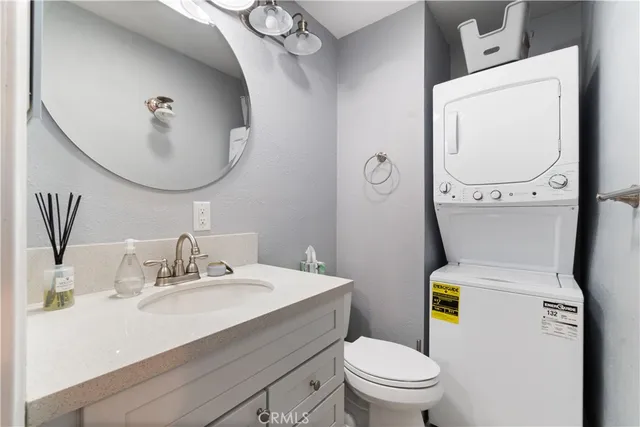 a bathroom with a sink mirror vanity and toilet