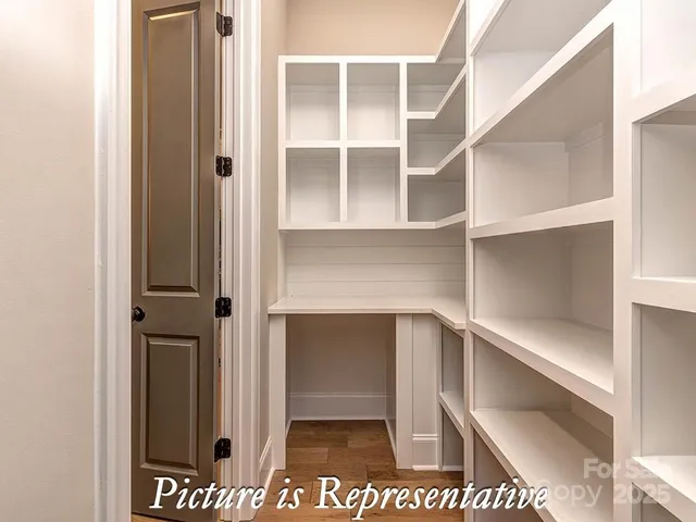 a view of staircase with railing and a chandelier